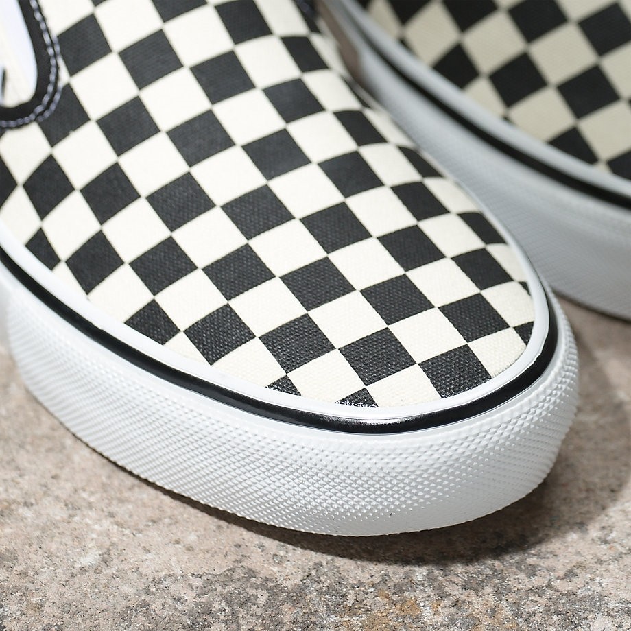 Tan checkerboard sales slip on vans